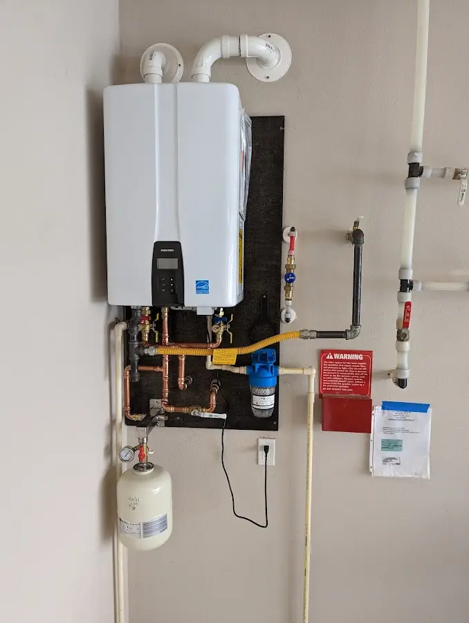 Professional plumber installing copper piping in a East Lake home